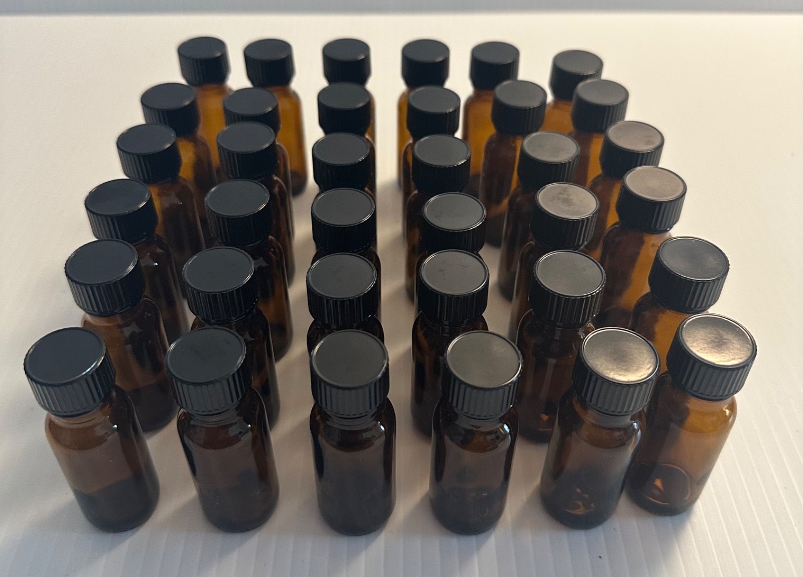 Boston Round 1/2 oz Amber Glass Bottles With Poly Lined Black Caps