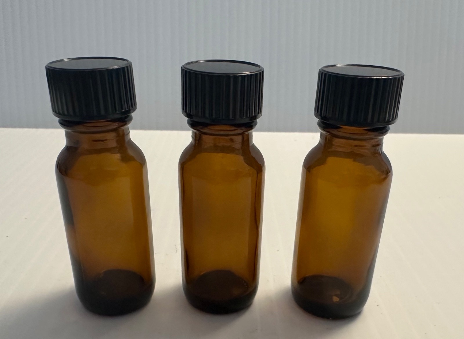 Boston Round 1/2 oz Amber Glass Bottles With Poly Lined Black Caps